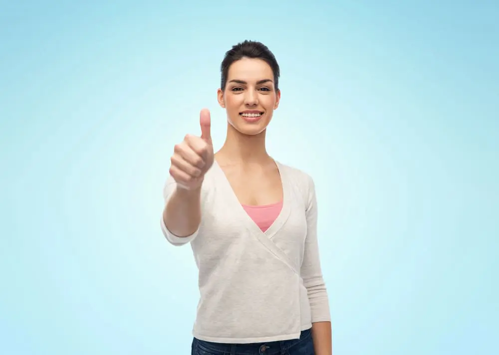 A smiling person gives a thumbs-up. Chauncey Orthodontics in Henderson, NV offers clear braces as an orthodontic treatment option.