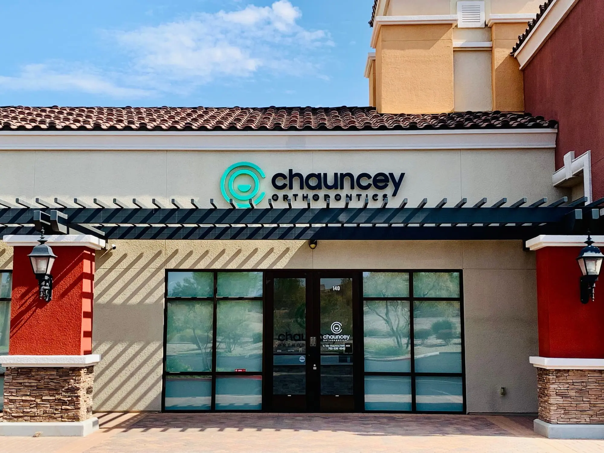 The exterior of Chauncey Orthodontics in Henderson, NV, features a modern storefront with the clinic's name and logo clearly displayed.
