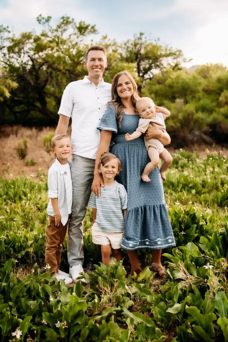A smiling family of five poses outdoors. Chauncey Orthodontics, located in Henderson NV, provides orthodontic care for all ages.