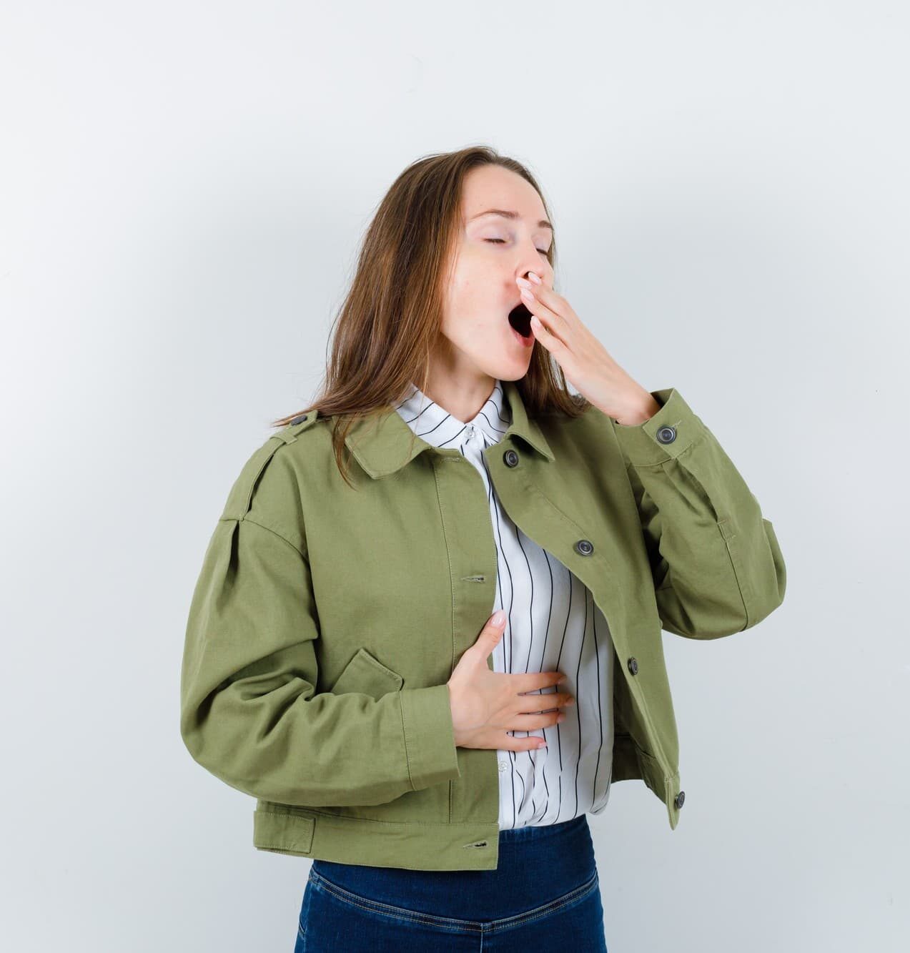 A woman wearing a green jacket discreetly covers his mouth, possibly to avoid revealing any mouth breathing when visiting Chauncey Orthodontics in Henderson, NV.